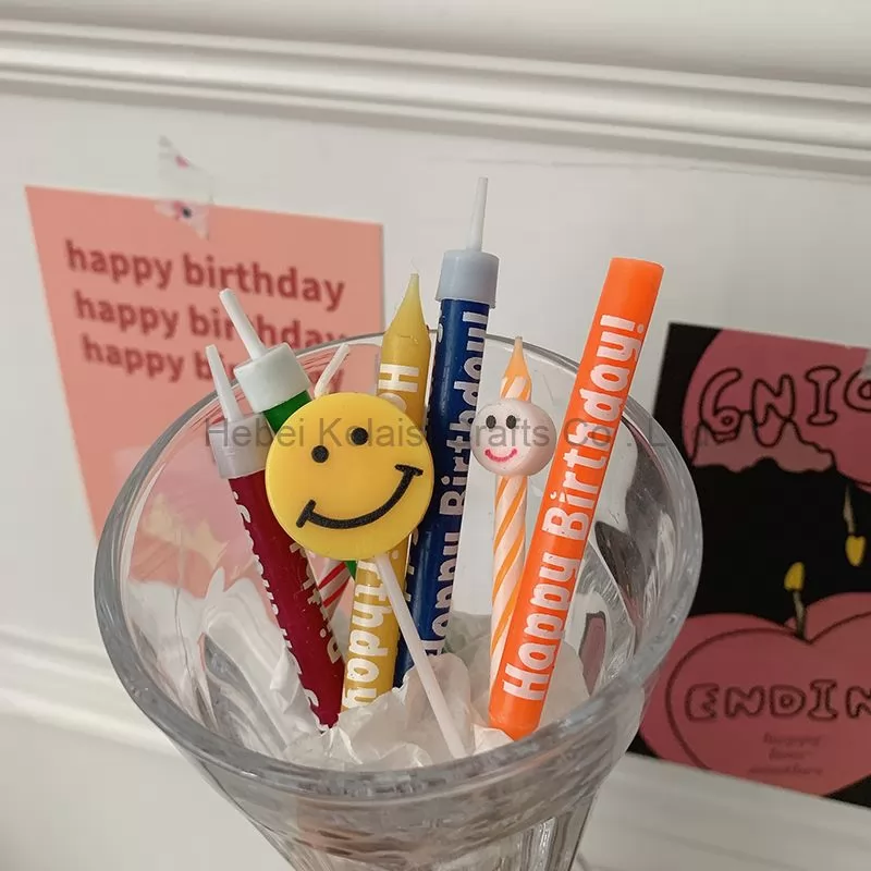 Yellow smiley face cartoons decorate birthday candles