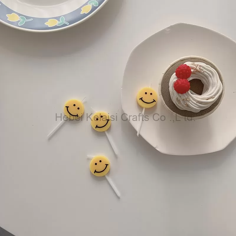 Yellow smiley face cartoons decorate birthday candles