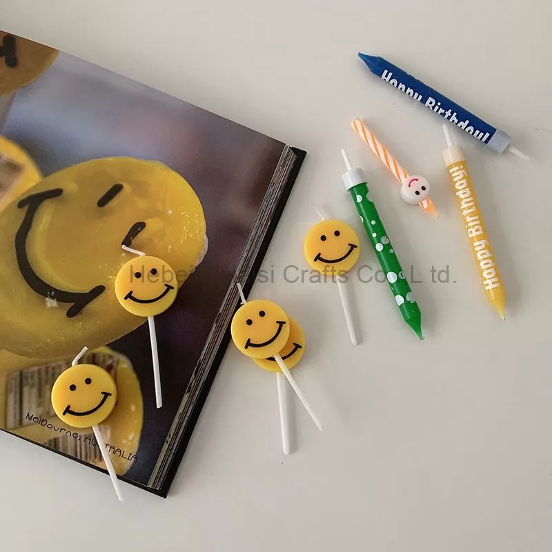 Yellow smiley face cartoons decorate birthday candles