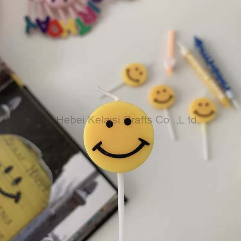 Yellow smiley face cartoons decorate birthday candles