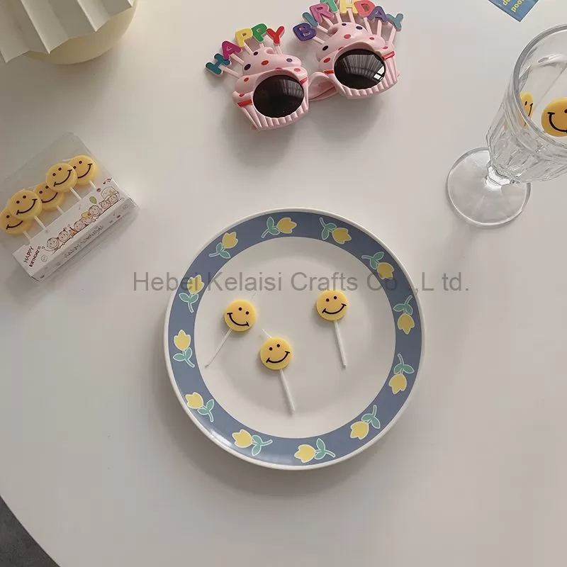 Yellow smiley face cartoons decorate birthday candles