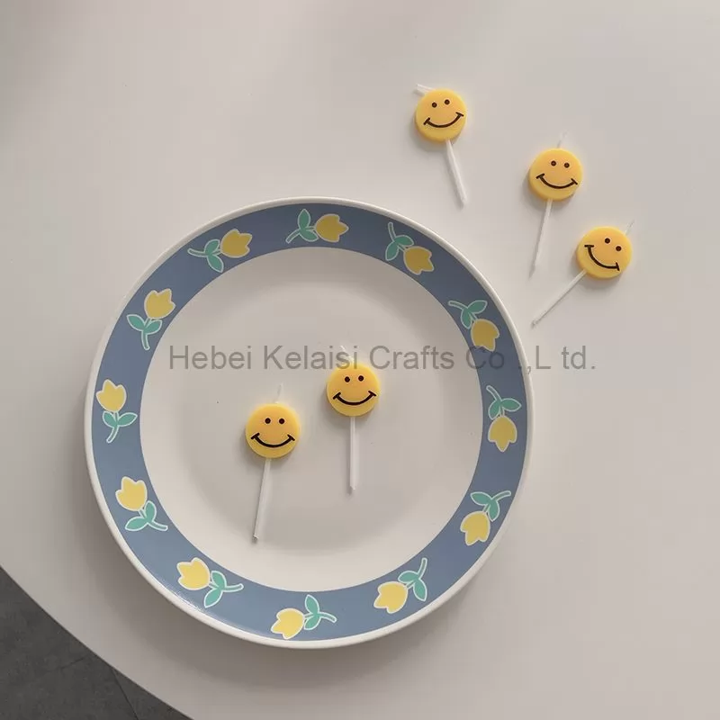 Yellow smiley face cartoons decorate birthday candles