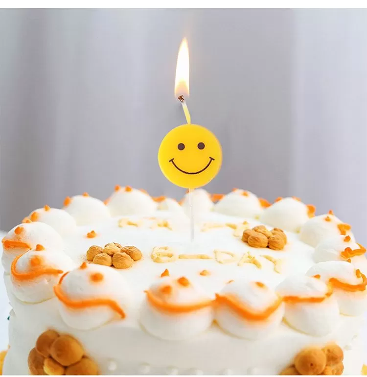 Yellow smiley birthday cartoon candle